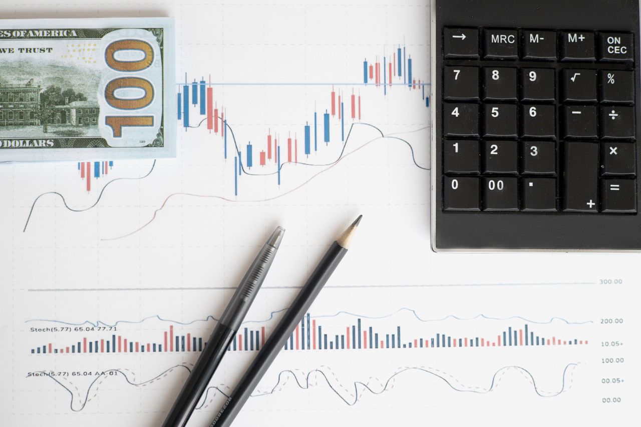 services-02 Stock analysis workspace featuring charts, a calculator, and currency for data-driven insights.